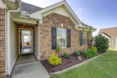 Welcoming entrance and pretty landscaped flower bed.