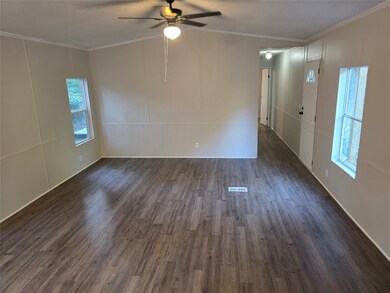 Spare room featuring ornamental molding, dark wood-style floors, ceiling fan, and vaulted ceiling