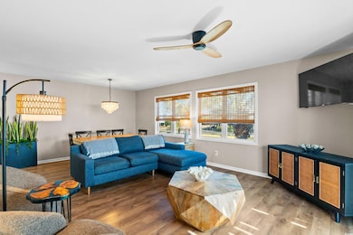 Living area with ceiling fan with notable chandeli