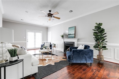 Expansive living room featuring hardwood floors, a cozy gas fireplace, and seamless flow into the kitchen — perfect for everyday living and entertaining