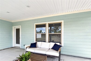 photo of furnished model exterior covered patio