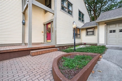 Welcoming brick entry with gas lamps fueled by underground propane tanks