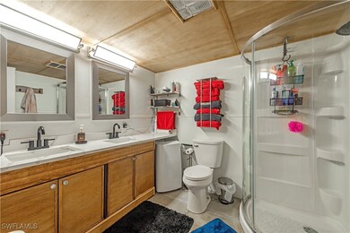 Full bath with double vanity, a shower stall, toil