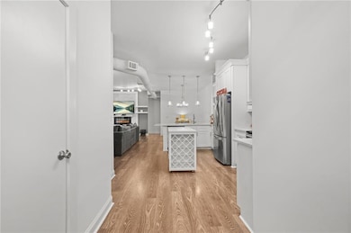 Kitchen with a center island, visible vents, white