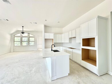 Kitchen with black electric cooktop, a center isl