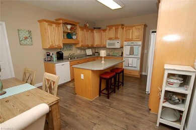 A view of the kitchen from the entry. Wonderful cabinet space and a double oven make cooking in here a pleasure!