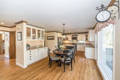 The charming kitchen features a built-in butler's hutch for serving and storage; hardwood floors, stainless steel appliances; a center island; and loads of charm.