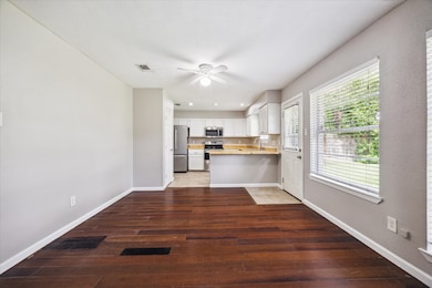 Dining area with wood floors and ceiling fan