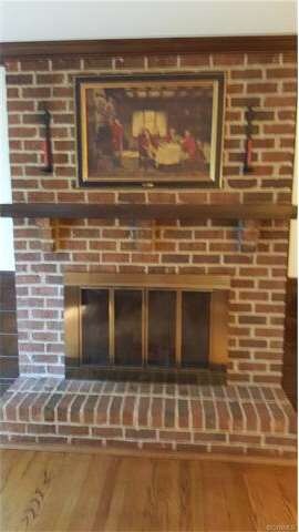 Raised hearth brick fireplace.