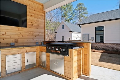 Outdoor grilling station with sink