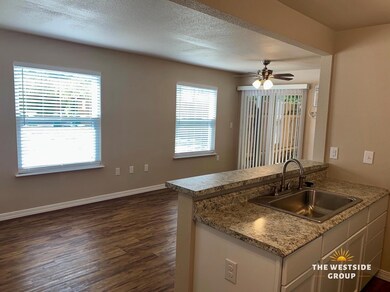 Kitchen featuring a sink, a ceiling fan, a textur