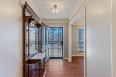 Foyer entrance with a textured ceiling, baseboards