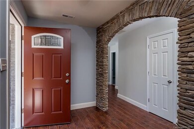 Glass front door leads to another stone archway!