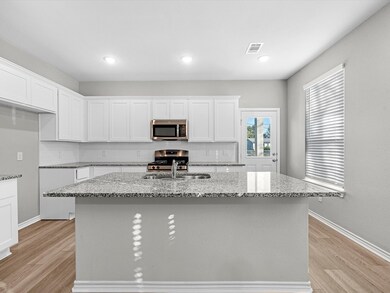 The kitchen boasts ample counter space which can d