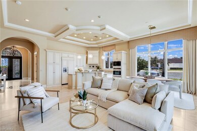 Tiled living room featuring coffered ceiling, a ch