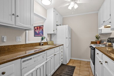 Galley style kitchen with granite counters. All ap