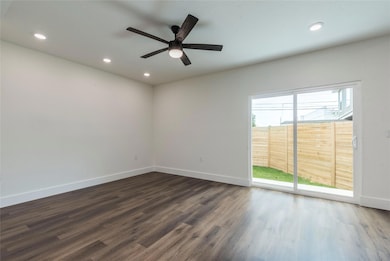 Empty room with dark wood-type flooring, recessed