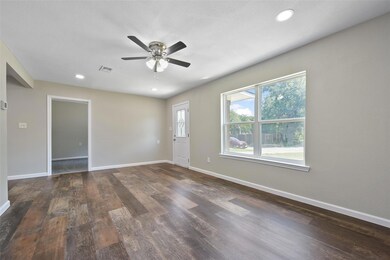 Living room featuring ceiling fan, wood-type floor
