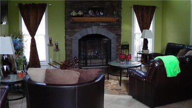 19 foot ceiling in living room with recessed lighting and stone fireplace. Travertine floors. 