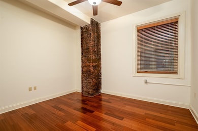 Spare room with wood finished floors and a ceiling fan
