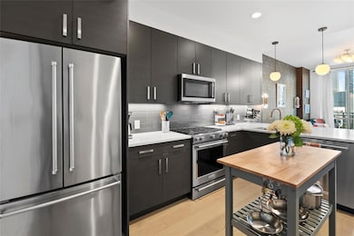 Kitchen featuring light countertops, stainless st