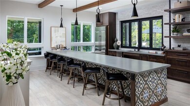 Kitchen featuring beamed ceiling, appliances with 