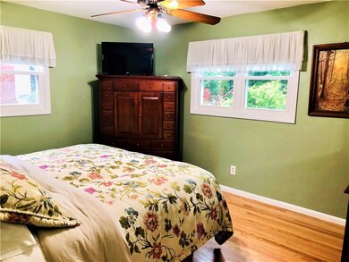The spacious master bedroom with hardwood floors e