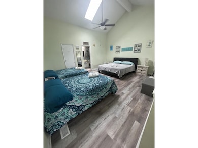 Bedroom featuring a skylight, ceiling fan, high va