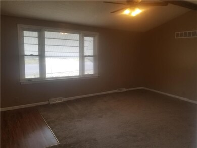 Spacious living room has vaulted ceiling. All new 