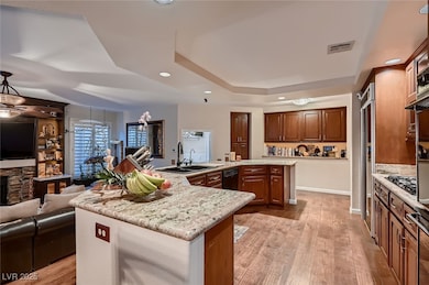 Kitchen featuring a large island with sink, a tray