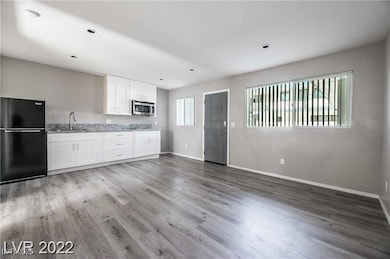 Kitchen featuring freestanding refrigerator, stain