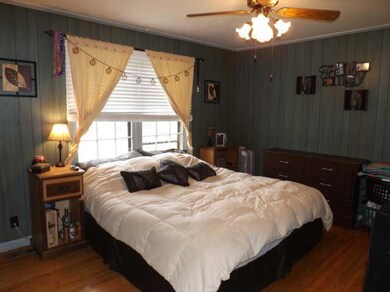 The master bedroom features beautiful hardwood floors, large picture windows, an extra large closet and a half bath.