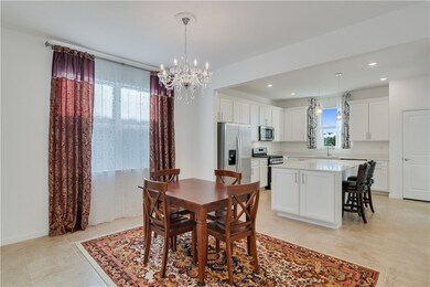 Dining space featuring a chandelier, light tile patterned floors, and recessed lighting