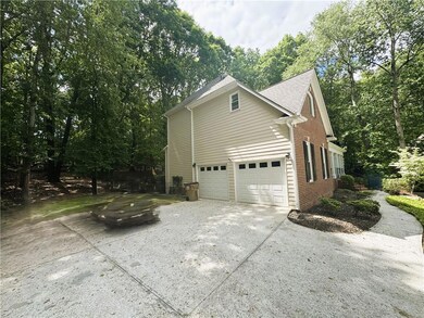 View of side of property featuring concrete drivew