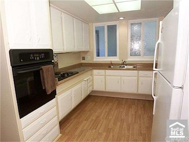 Kitchen features newer appliances, raised counters