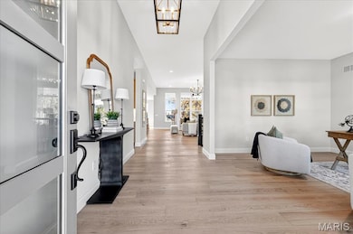 Entryway featuring a chandelier and light wood-style flooring