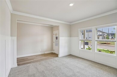 Empty room featuring carpet flooring, ornamental molding, and recessed lighting