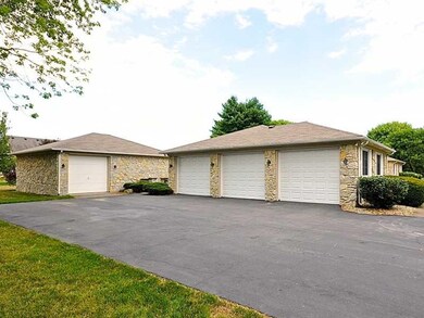 Garage. The three car attached garage is currently outfitted with a workshop. The detached one car has an office and half bath as well as heat and a/c.