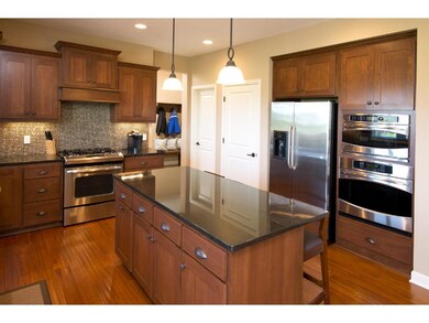 Island and counters feature granite and glass back