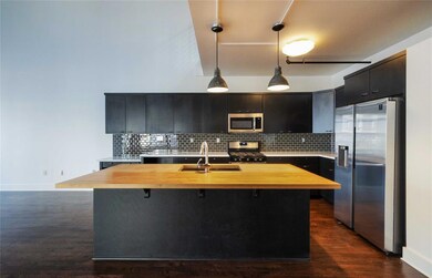 Kitchen with decorative backsplash, stainless ste