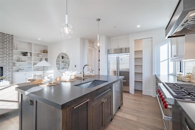 Kitchen featuring dark brown cabinets, exhaust hoo