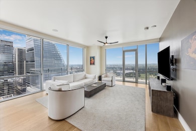 Living room with a wall of windows, a healthy amo