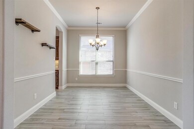 Unfurnished dining area with crown molding, an inviting chandelier, and light hardwood / wood-style floors