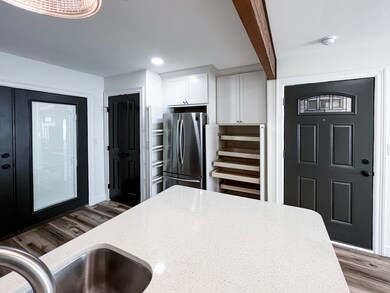Modern kitchen featuring a pantry with convenient