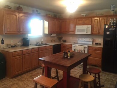 Great kitchen with lots of cabinets, frig, dishwasher, microwave & oven