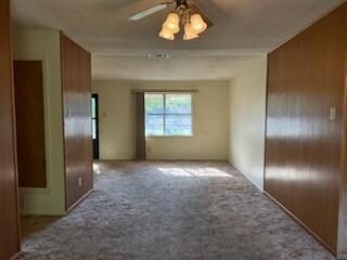 Carpeted empty room with a textured ceiling