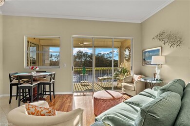 Living area featuring baseboards, crown molding, a