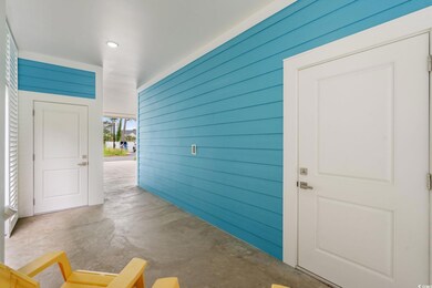 Hallway featuring concrete flooring, wooden walls, and recessed lighting