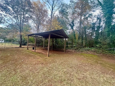 View of yard with a carport