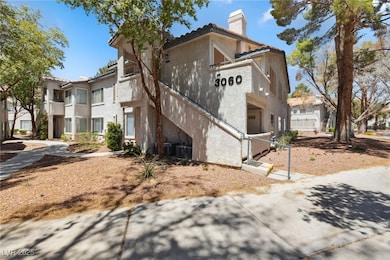 View of home's exterior featuring a chimney, a til